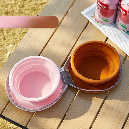 Gamelle pliée en rose pastel avec coque rigide pour chien, facile à ranger et à emporter.