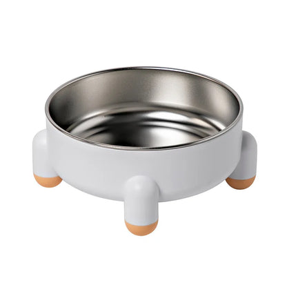 Gamelle pour chien blanche au style minimaliste avec quatre pieds ronds et bol en acier inoxydable.
