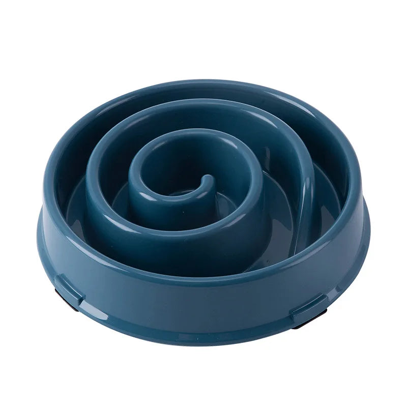 Gamelle anti-glouton spirale bleu foncé avec rebords arrondis, posée au sol.